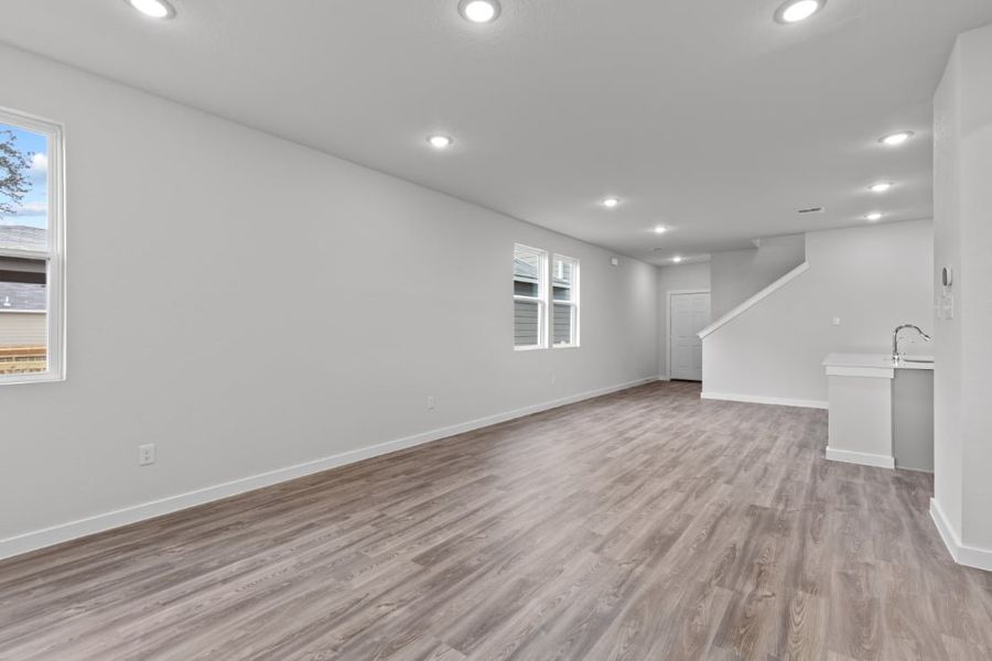 A room with a wood floor and a sink.