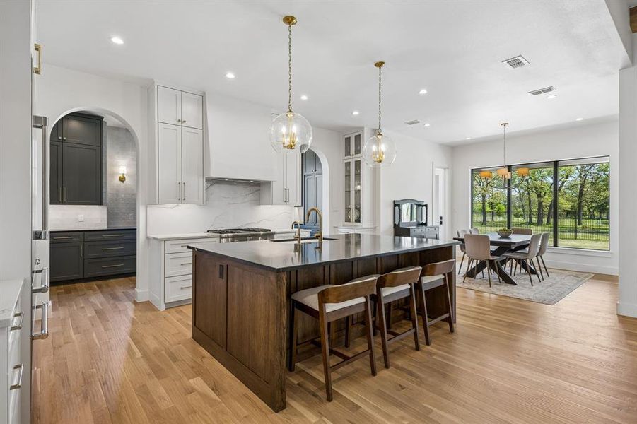 Spacious kitchen seamlessly integrated with the dining area, offering a delightful greenbelt view.