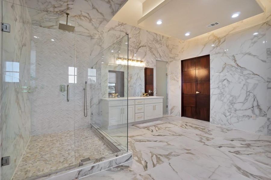 Bathroom with vanity and a shower with shower door