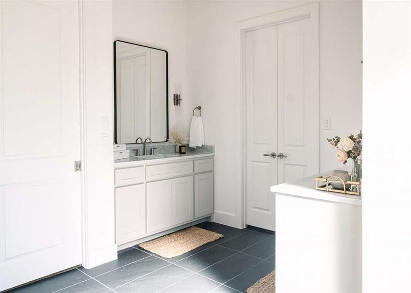 Bathroom with tile patterned flooring and vanity