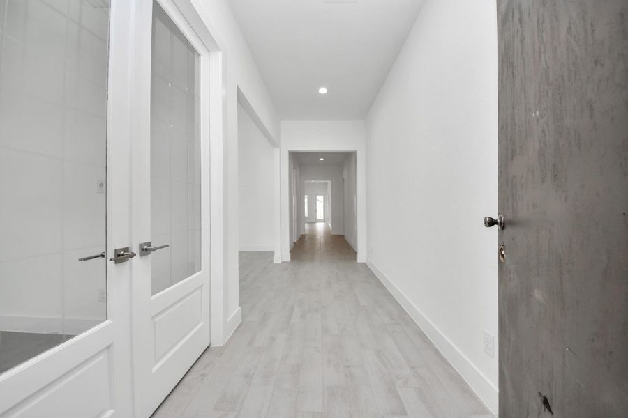 As you step into the threshold of this luxurious home, you'll soon be welcomed by an elegant glass door (to be installed). Inside, soaring ceilings amplify the spaciousness, while the refined wood-look tile flooring and oversized baseboards exude sophistication and charm.