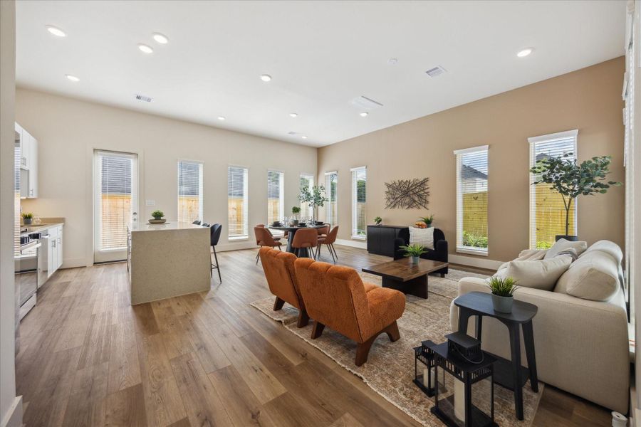 The kitchen flows effortlessly into the dining and living areas, with a spacious island that invites casual conversation and shared moments.