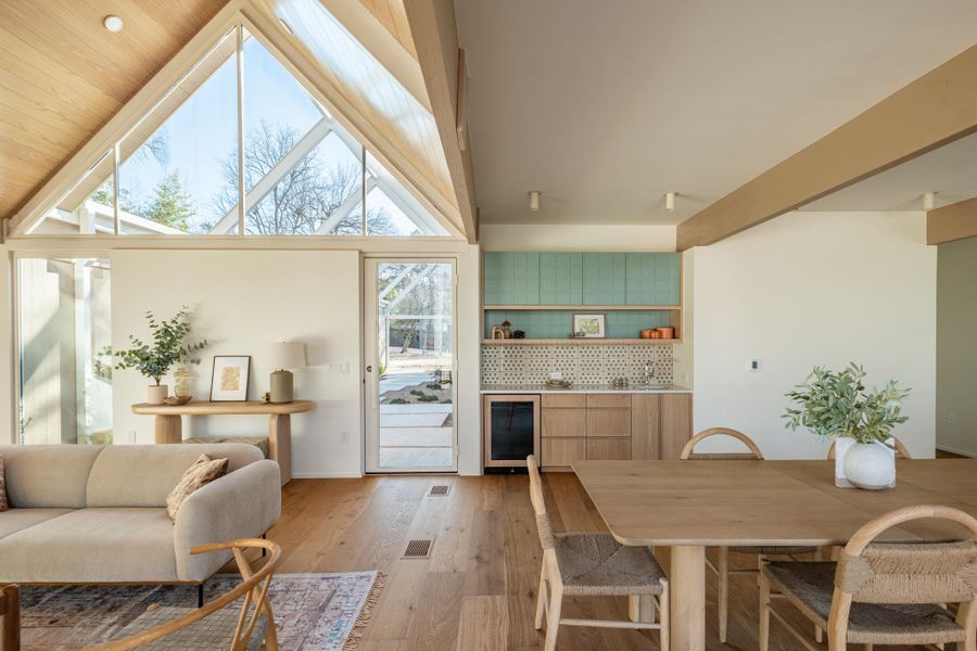 Dining area with wine cooler and light wood-style flooring