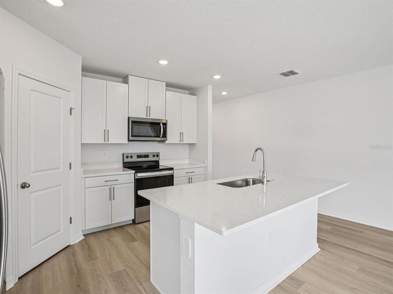 Furnished interior view inside a new home in The Grove at Stuart Crossing - Classic Series, Bartow (Image 11).