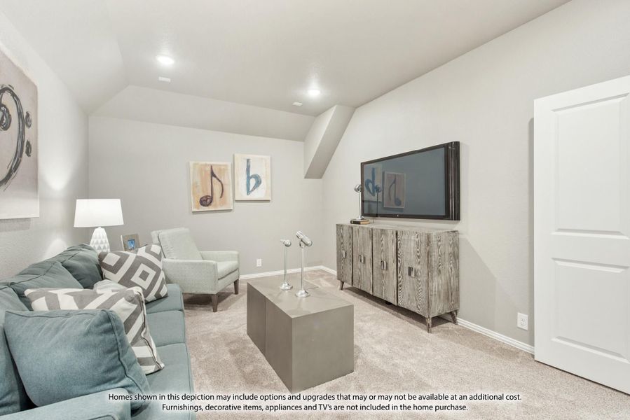 Living room with vaulted ceiling, teal sofa, wall-mounted TV, and wood media console on carpet