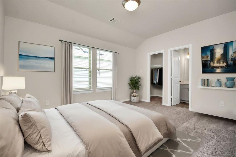 This light-filled master bedroom creates a haven for relaxation and unwinding. Imagine adding a ceiling fan for cool comfort, storing your belongings in a spacious closet, and enjoying the convenience of an en-suite bathroom. **This image is from another Saratoga Home with similar floor plan and finishes, not the Brittany floorplan.**