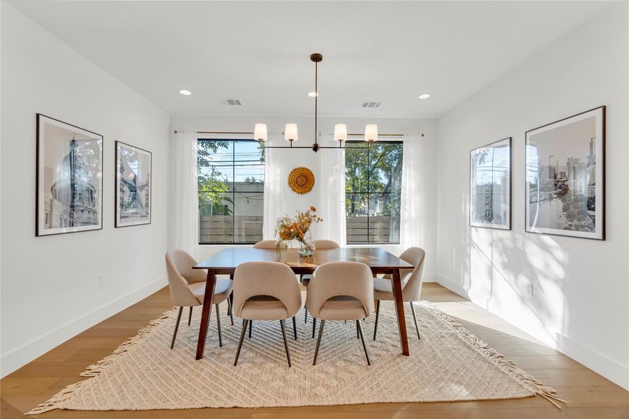 Dining space featuring wood finished floors, a chandelier, and recessed lighting Dining space featuring wood finished floors, a chandelier, and recessed lighting