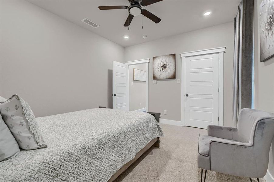 Bedroom featuring ceiling fan and carpet