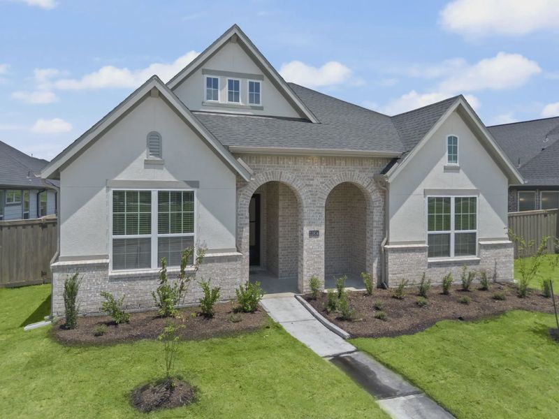 Representative exterior photo of a completed home built from the Mickelson by Chesmar Homes in Riceland Alley Loads, Mont Belvieu, TX (Image 37).