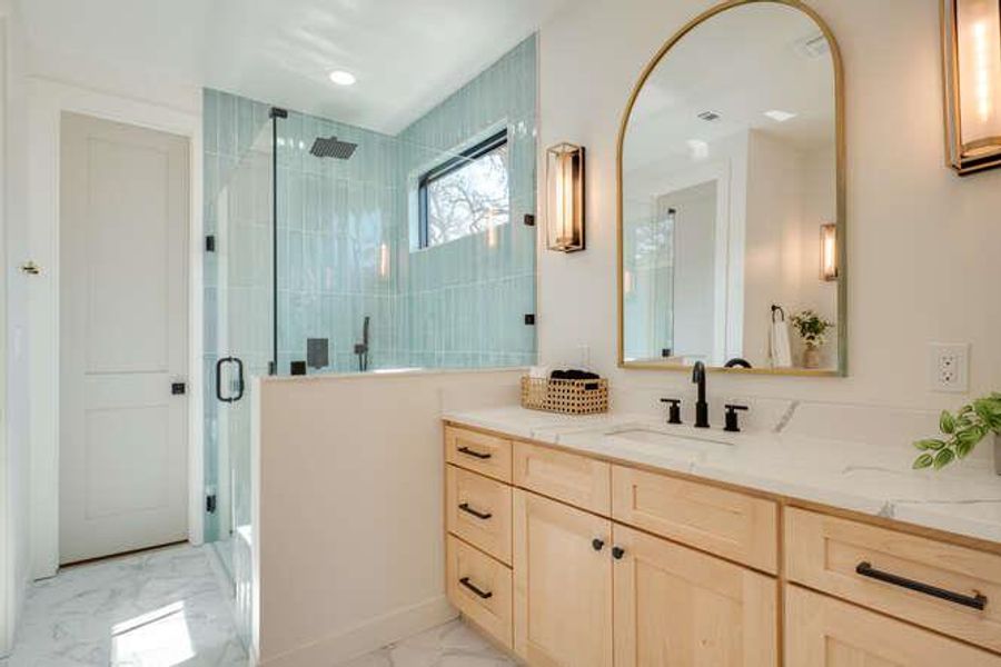 Full bathroom with vanity, a stall shower, and light marble finish floors