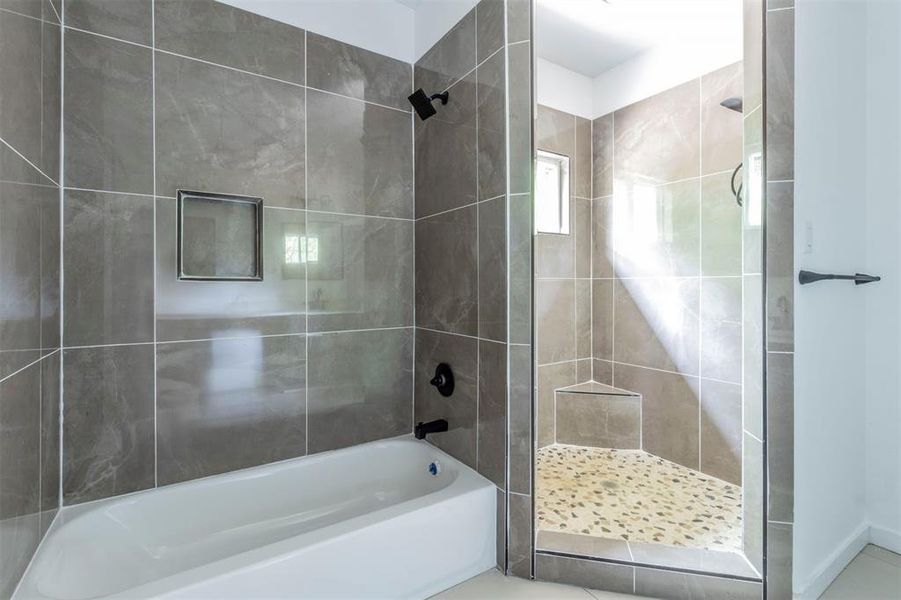 Full bathroom featuring a tile shower and a bath Full bathroom featuring a tile shower and a bath