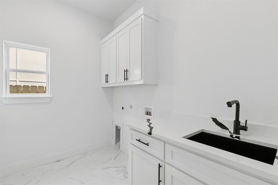 Washroom featuring hookup for a washing machine, hookup for a gas dryer, light marble finish flooring, cabinet space, and hookup for an electric dryer