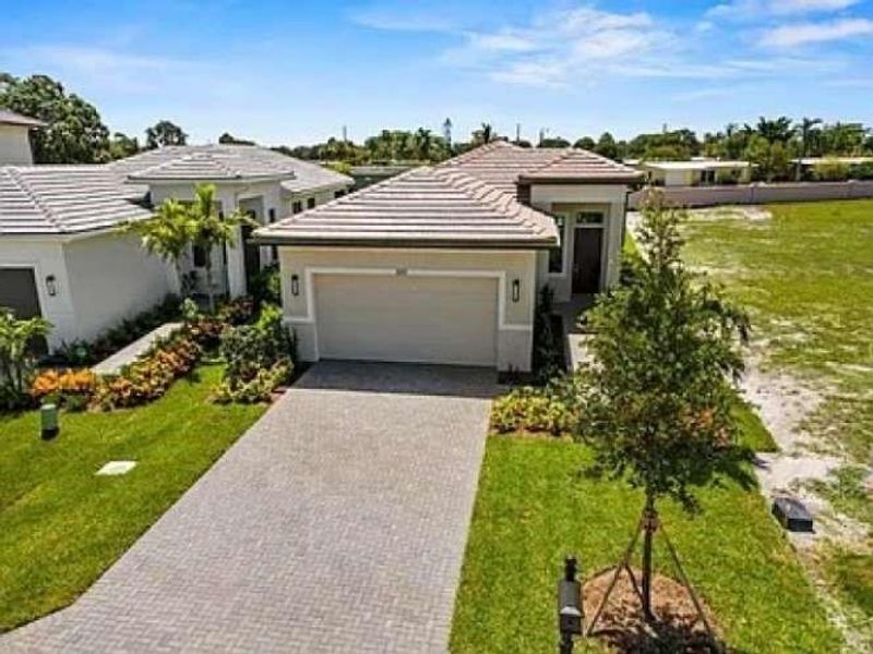 Front exterior of a new home in , Port St. Lucie, FL, highlighting curb appeal (Image 2).