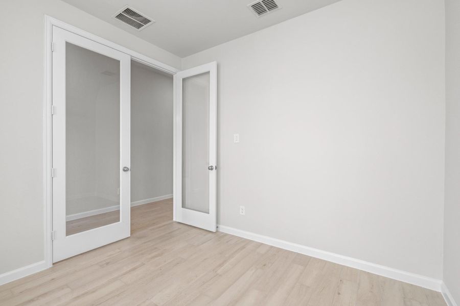 Private home office or flex room with French doors, ideal for working from home or study.