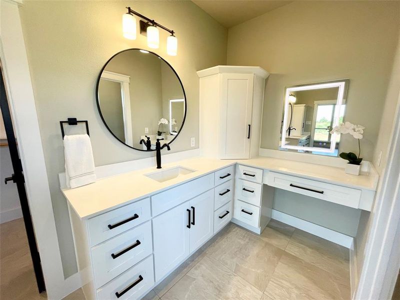 Bathroom featuring tile patterned floors and vanity