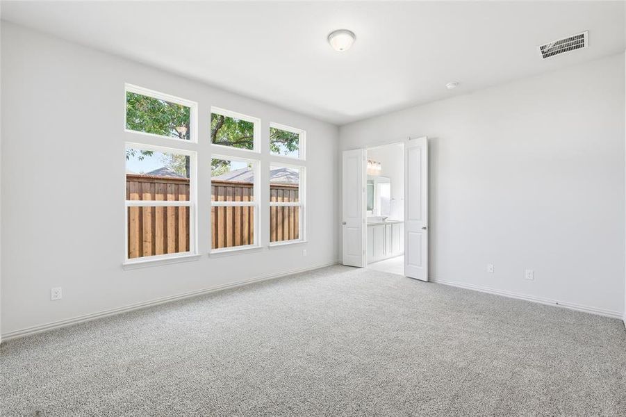 Carpeted spare room with baseboards