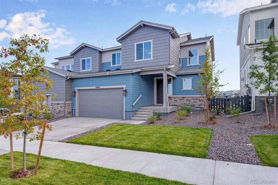 Front exterior of a new home in Wild Oak at The Canyons, Castle Pines, CO, highlighting curb appeal (Image 2). Front exterior of a new home in Wild Oak at The Canyons, Castle Pines, CO, highlighting curb appeal (Image 2).