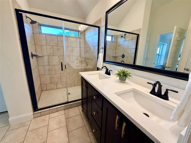 Bathroom featuring a dual vanity with white countertops, undermount sinks, and black fixtures Bathroom featuring a dual vanity with white countertops, undermount sinks, and black fixtures