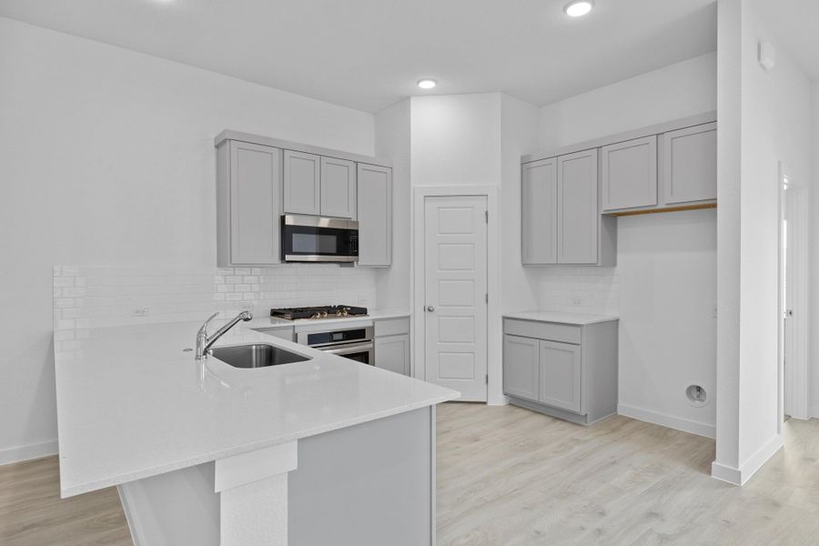 Kitchen in the Pecan II home plan by Trophy Signature Homes – REPRESENTATIVE PHOTO Kitchen in the Pecan II home plan by Trophy Signature Homes – REPRESENTATIVE PHOTO