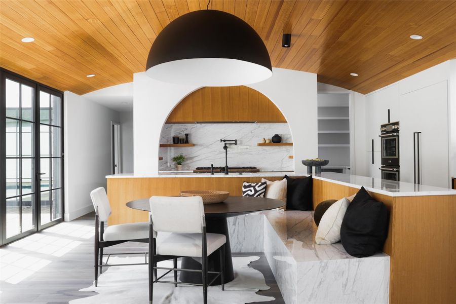 Warm walnut cabinetry is featured in the incredible kitchen that is made for entertaining.