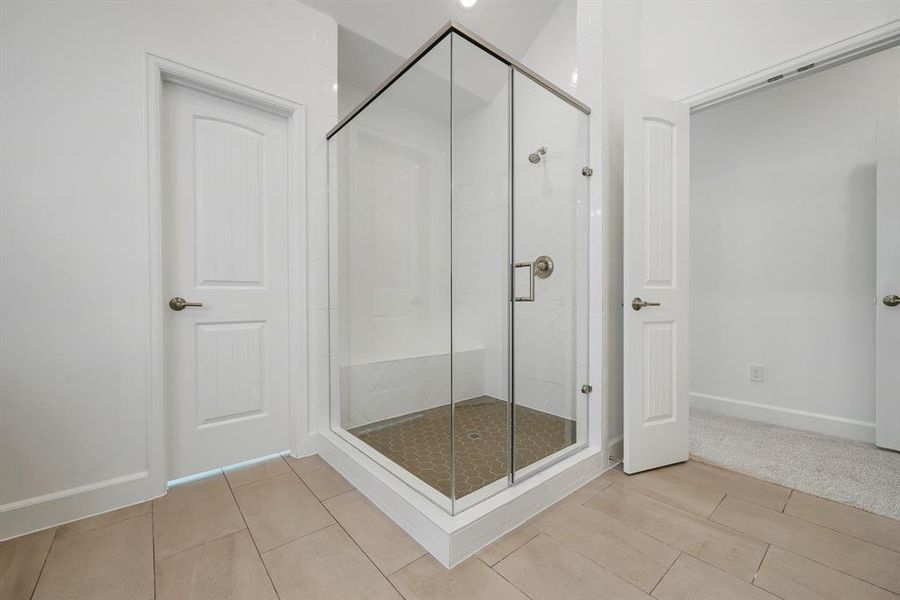 The Primary Bath is highlighted by the spacious shower! (Sample photos of a completed Lisbon floor plan. The image may feature alternative selections and/or upgrades.)