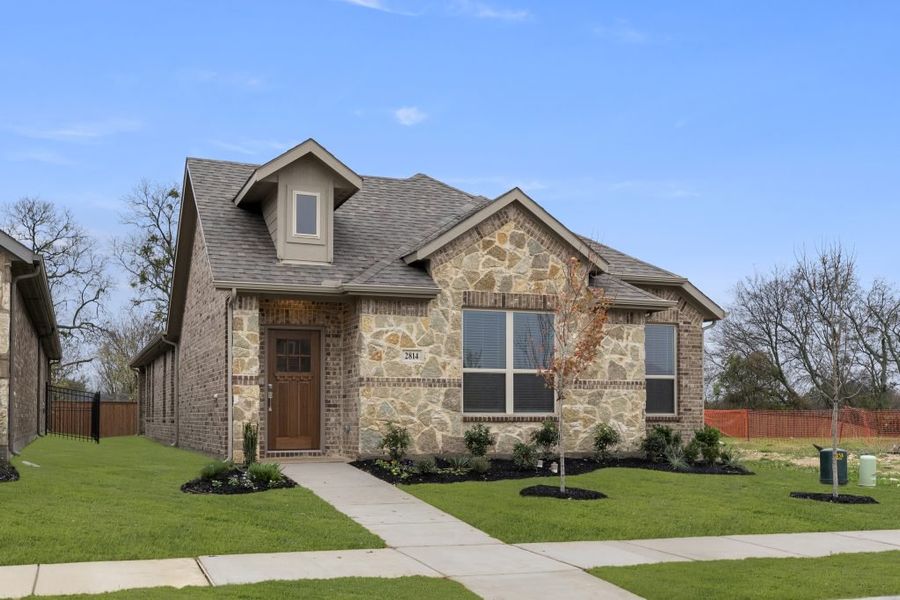 Front exterior of a new home in Redden Farms – Active Adult, Midlothian, TX, highlighting curb appeal (Image 2).
