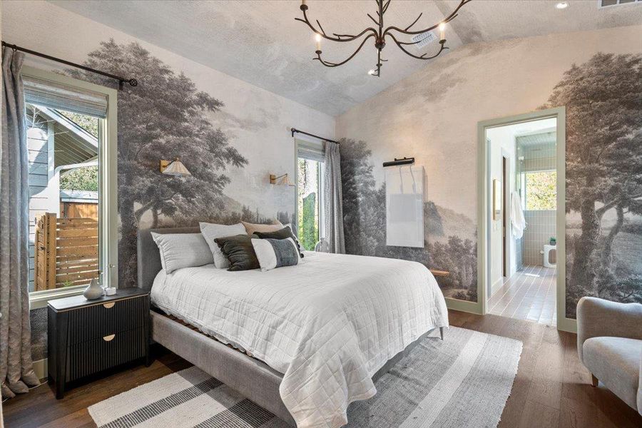 The primary bedroom showcases Phillip Jeffries wallpaper printed on Manila hemp.