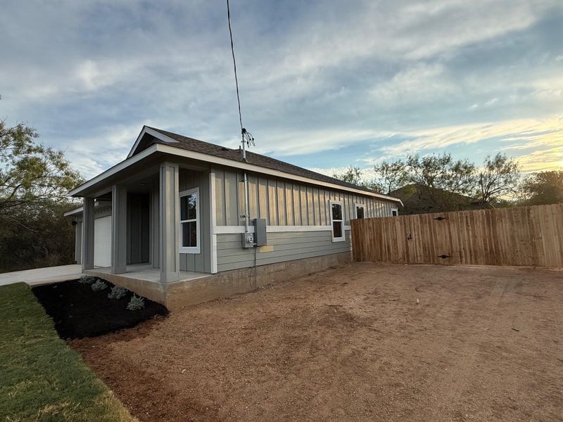 View of home's exterior featuring board and batten siding and roof with shingles