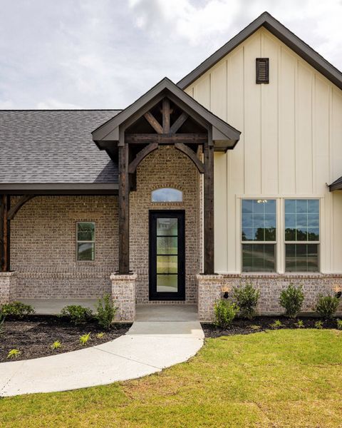 Front exterior of a new home in Prairie Winds Estates, Poolville, TX, highlighting curb appeal (Image 22). Front exterior of a new home in Prairie Winds Estates, Poolville, TX, highlighting curb appeal (Image 22).