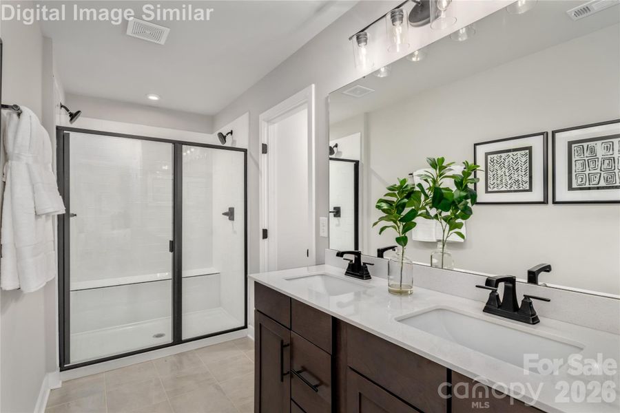 The Walk-in Shower With Framed Glass Door.  It's A Stylish Statement That Anchors The Room With Visual Structure while Creating A Spa-Like Feel.
