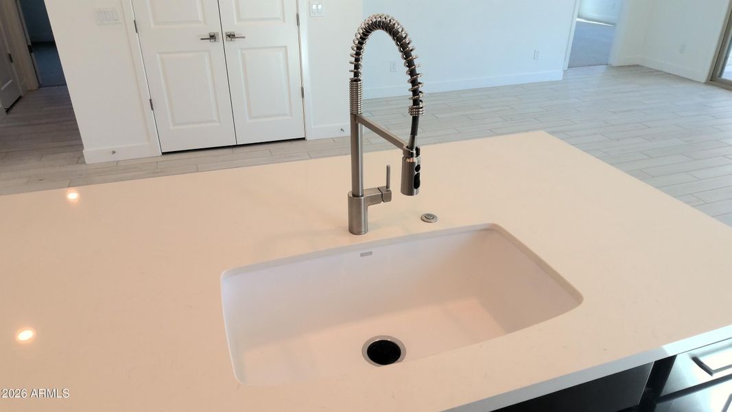 Single bowl sink with hi-arc faucet