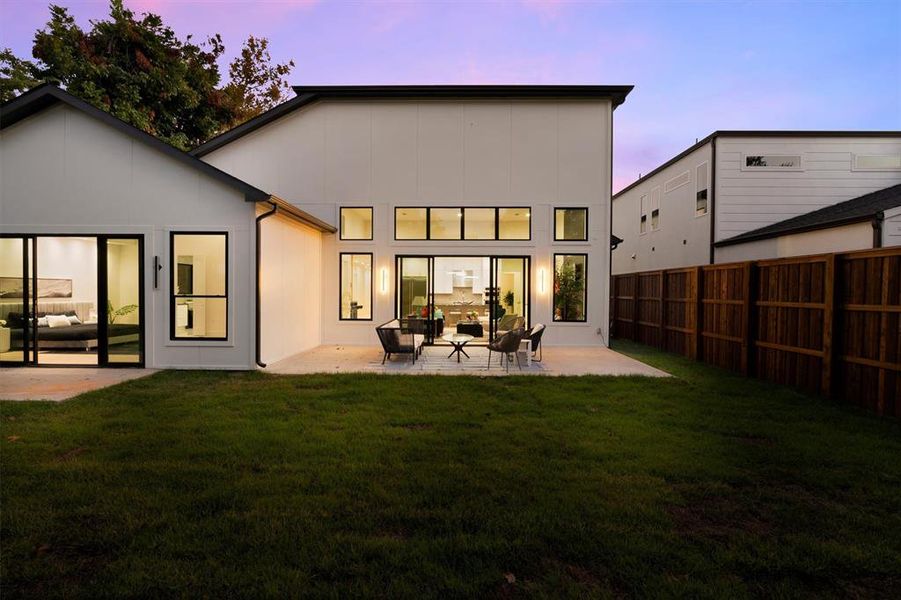 Back of house at dusk featuring a patio and outdoor lounge area Back of house at dusk featuring a patio and outdoor lounge area