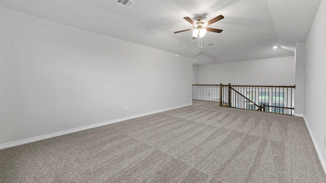 Spare room featuring ceiling fan, vaulted ceiling, light carpet, and recessed lighting Spare room featuring ceiling fan, vaulted ceiling, light carpet, and recessed lighting