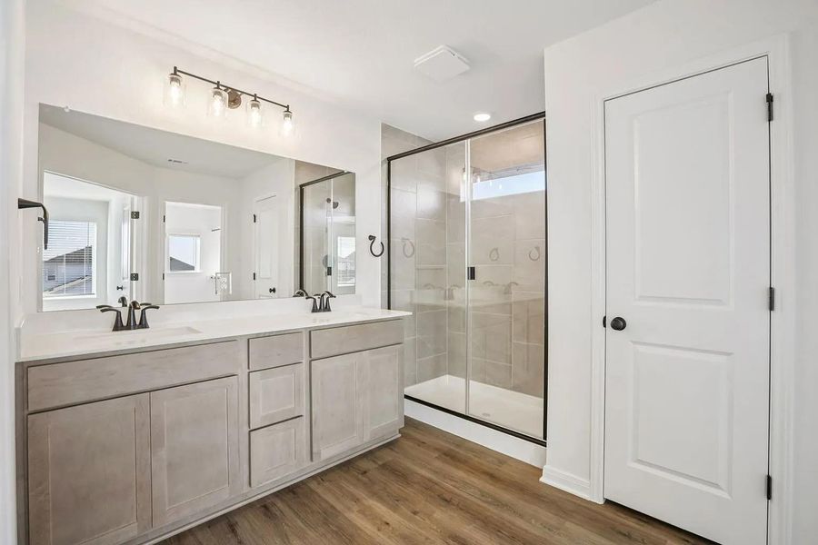 Dual vanity sinks complement the spacious walk-in shower in this well-appointed bathroom. Dual vanity sinks complement the spacious walk-in shower in this well-appointed bathroom.