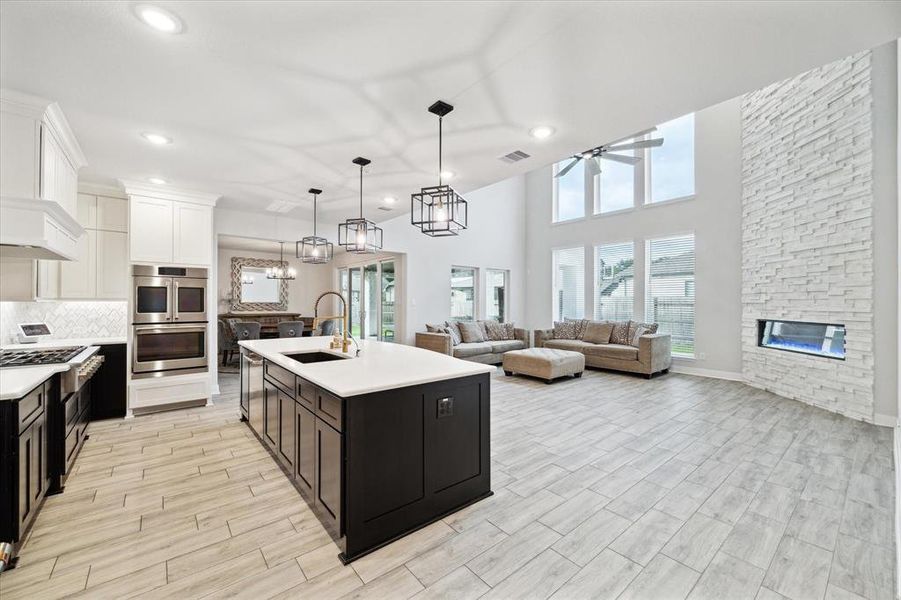 Open concept living, dining and kitchen area are all perfect for entertaining.  The prominent floor to ceiling windows allow plenty of natural lighting to shine through the entire area.