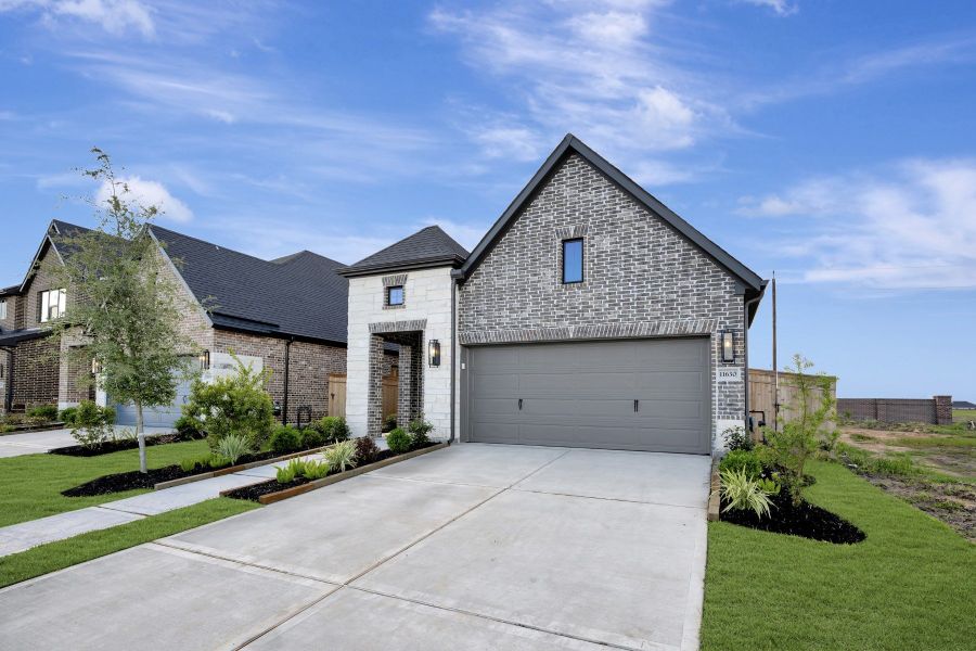 Front exterior of a new home in Sienna - Grove Collection, Missouri City, TX, highlighting curb appeal (Image 28). Front exterior of a new home in Sienna - Grove Collection, Missouri City, TX, highlighting curb appeal (Image 28).