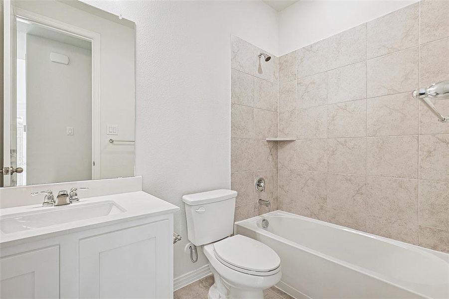 Full bath with vanity, tub / shower combination, and a textured wall
