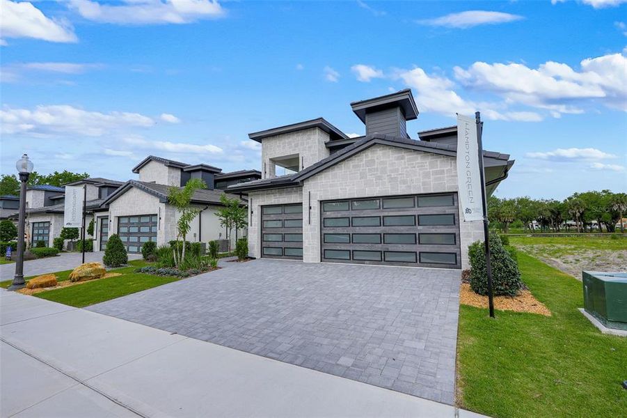 Front exterior of a new home in Hampton Green at Providence, Davenport, FL, highlighting curb appeal (Image 30).
