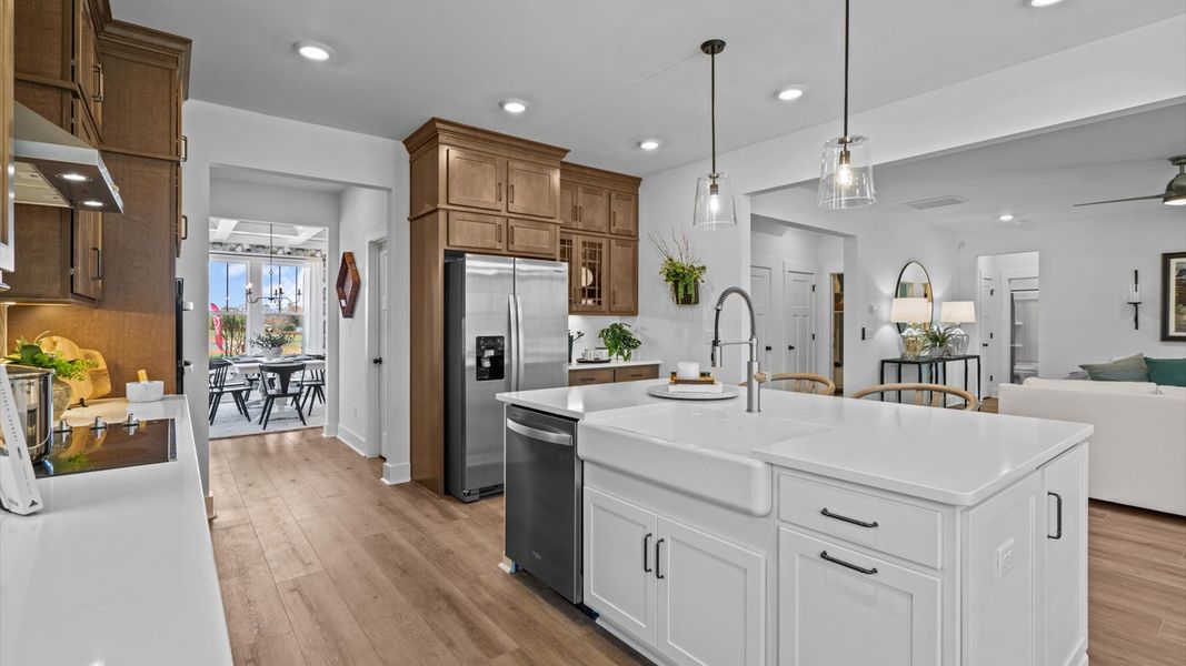 Elegant kitchen with large island and pendant lighting in this first-class DRB Homes design