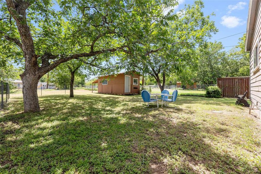 Fenced backyard featuring an outbuilding Fenced backyard featuring an outbuilding