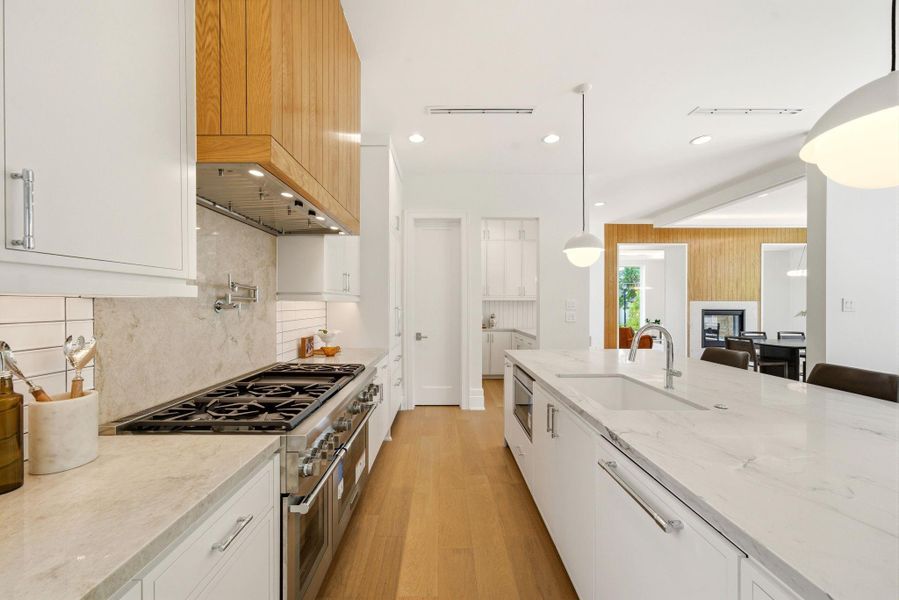 This gourmet kitchen offers amazing counter space for all your cooking needs. Overlooking the banquette seating and family room. This gourmet kitchen offers amazing counter space for all your cooking needs. Overlooking the banquette seating and family room.