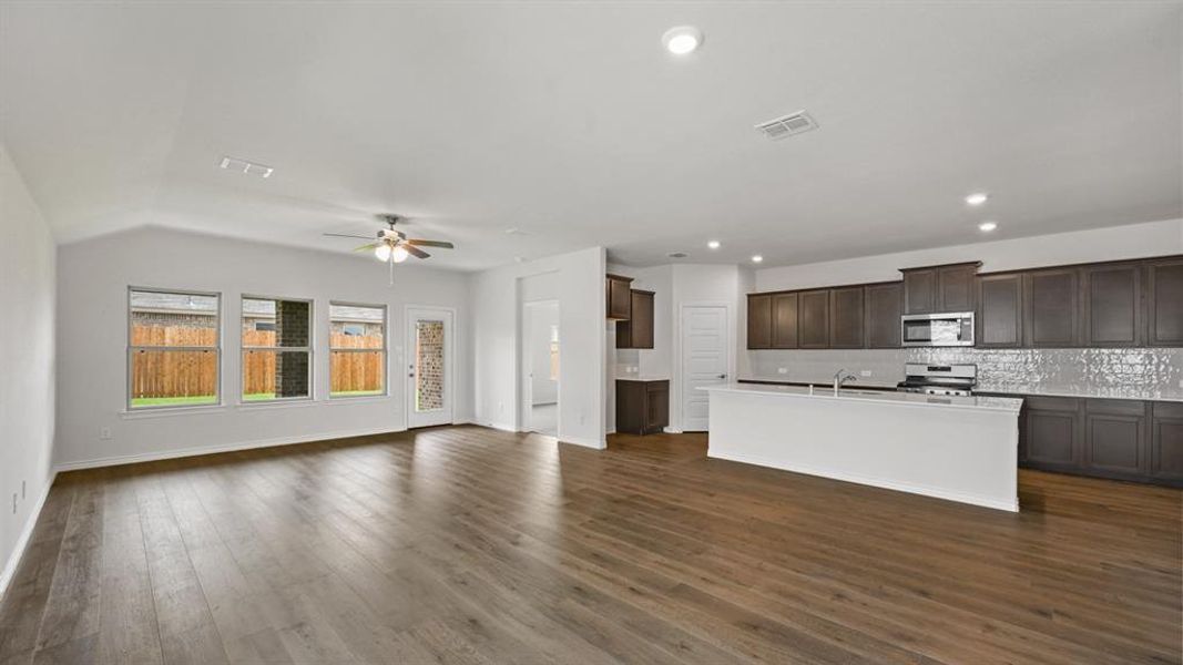Open-concept living space featuring wood-finish flooring, recessed lighting, and a ceiling fan Open-concept living space featuring wood-finish flooring, recessed lighting, and a ceiling fan