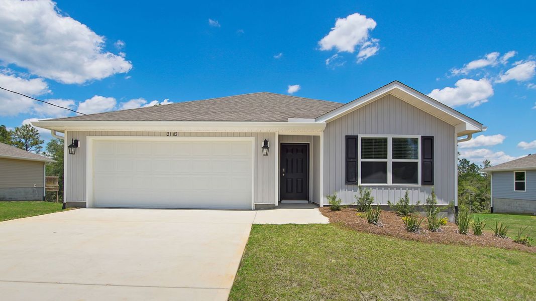 Front exterior of a new home in Magnolia at the Bluffs Phase 3, Freeport, FL, highlighting curb appeal (Image 2).