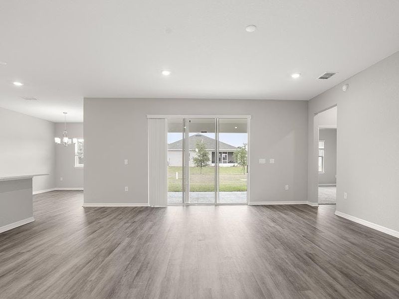 A triple sliding glass door opens to outdoor living space - Everly by Highland Homes