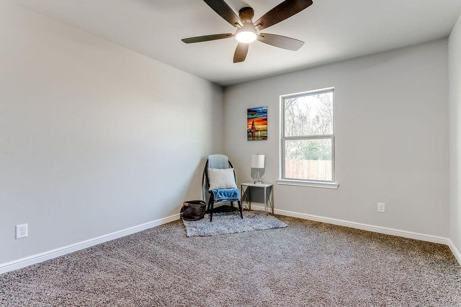 Unfurnished room featuring carpet flooring and ceiling fan