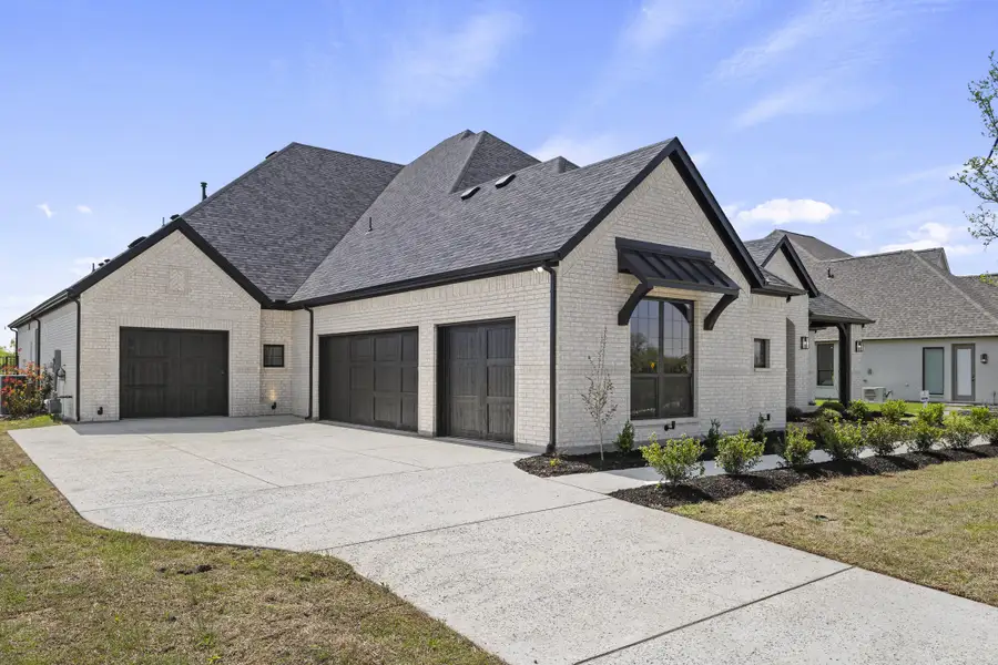 Front exterior of a new home in Winding Creek, Rockwall, TX, highlighting curb appeal (Image 2).