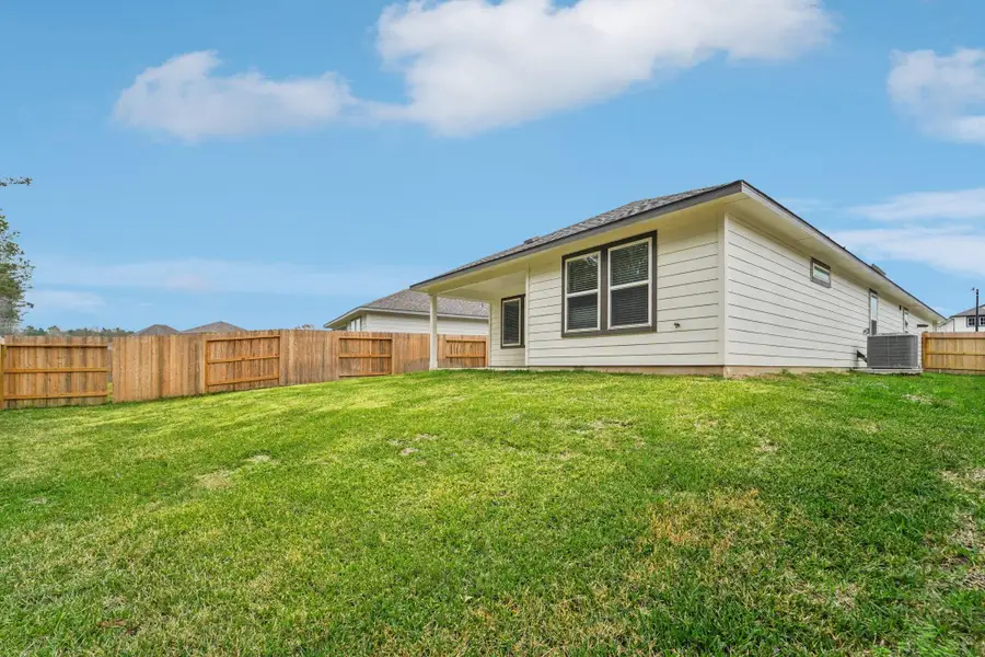 Exterior details and patio area of a home in Landing Meadows - Traditional Series, New Caney (Image 19).