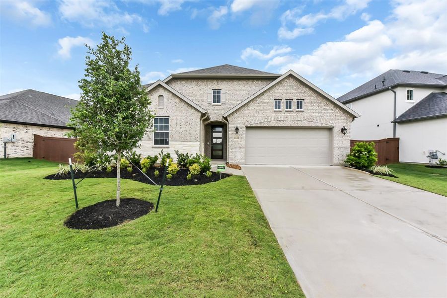 Front exterior of a new home in Evergreen 55', Conroe, TX, highlighting curb appeal (Image 1).