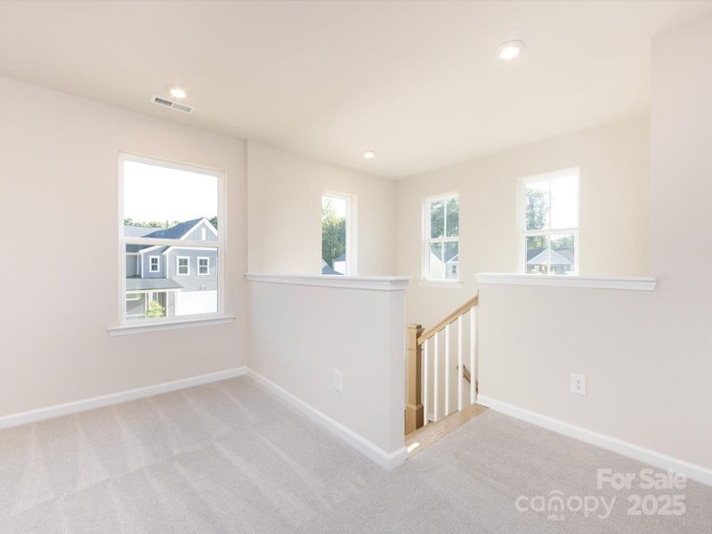 Bright landing leading to the loft with loads of windows to keep the space bright and airy.