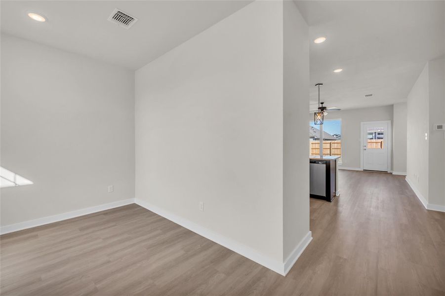 Spare room with wood finished floors, baseboards, visible vents, recessed lighting, and ceiling fan